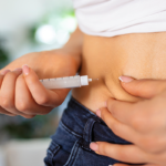 Woman self-administering an injectable medication at home, GLP-1 weight-loss treatment.